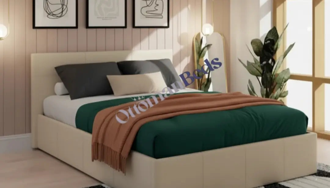 A modern Single Ottomans bed with a light upholstered frame, green bedding, brown throw, and pillows, placed in a bright bedroom with plants and wall art.