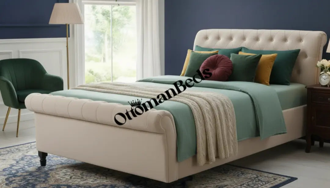 Elegant bedroom with a cream upholstered ottoman bed, soft green bedding, cushions, and window light. Ottomans Beds design adds comfort, storage, and style.