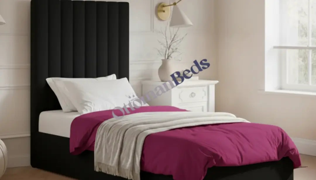 Modern bedroom with black padded headboard, white pillows, pink bedding, side table and wall lamp, styled neatly with Single Ottomans for comfort.